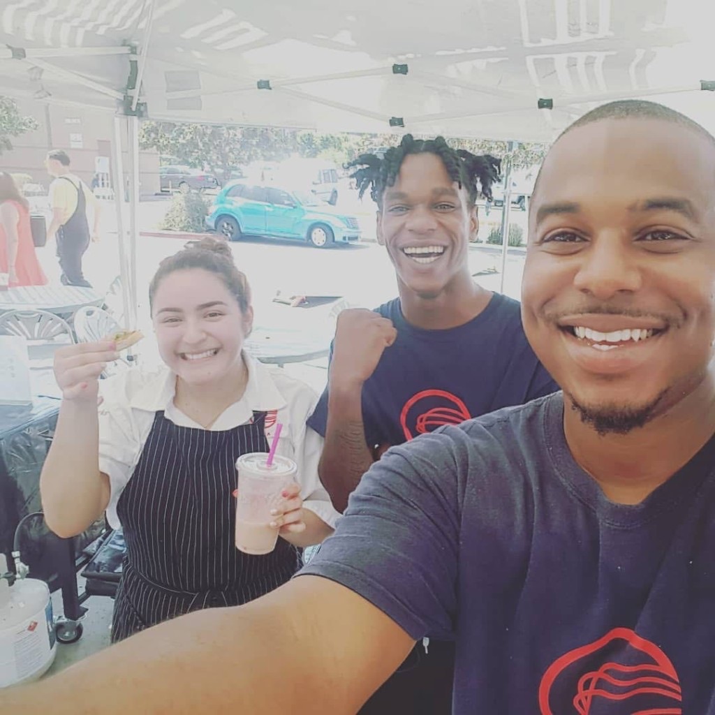 Chef Jelani mentoring C·CAP students at a community farmers market event