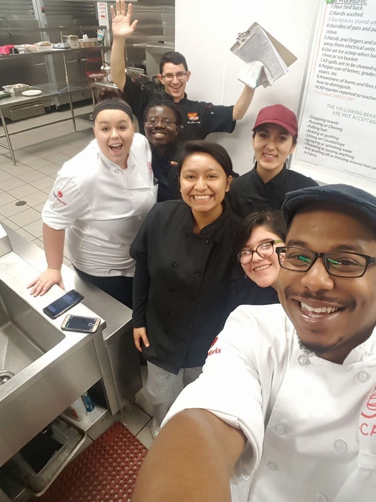 Chef Jelani with C·CAP students in a training kitchen