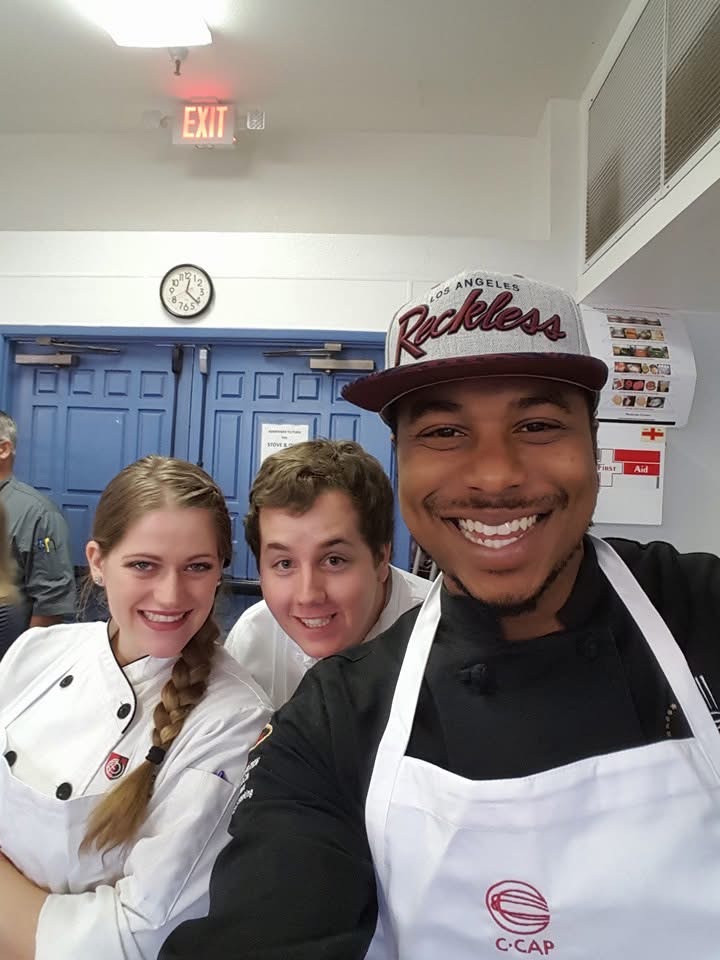 Chef Jelani with C·CAP students in a school kitchen
